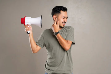 man pointing a megaphone towards his own ear